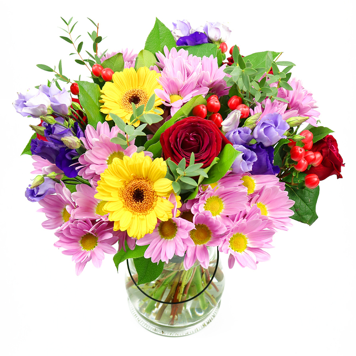 A striking mixed-flower bouquet fills a clear glass vase, the entire arrangement set against a smooth white background that lets every colour and texture take centre stage. In the middle of the design, velvety red roses open in layered spirals, their rich hue bringing a sense of depth and classic romance. Close by, a pair of bold yellow gerbera daisies with dark, warm-toned centres stretch out their wide petals like miniature suns, instantly giving the composition a burst of optimism and joy. Around these standout blooms, clusters of pink daisies and chrysanthemums spill outward, their numerous fine petals surrounding small yellow eyes and creating a soft, pastel cushion that adds both volume and gentle charm. Interspersed throughout are tall, slender stems of lisianthus in purples and lavenders, their bell-shaped flowers curving delicately to provide cool, graceful highlights between the warmer tones. Between the petals, bright red hypericum berries appear in small clusters, their smooth, rounded forms catching the light and adding a contemporary detail reminiscent of hedgerow berries found on walks through Bracknell Forest. Lush green foliage fans around the bouquet, a mix of deep, glossy leaves and lighter, more delicate sprigs that frame the flowers and suggest natural movement. Through the clear glass of the vase you can see the neatly cut stems immersed in clean water, testifying to the bouquet's freshness and the florist's attentive care. The arrangement feels both abundant and balanced, ideal as a celebratory gift delivered by Flower Delivery Bracknell Forest, whether for a birthday in a family home, a congratulations for a new job, or simply to bring the look and feel of a flourishing garden indoors.